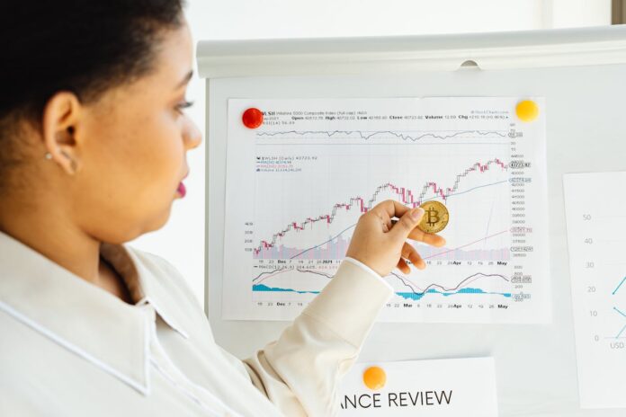 Photo by Photo By: Kaboompics.com: https://www.pexels.com/photo/woman-holding-a-bitcoin-7876495/