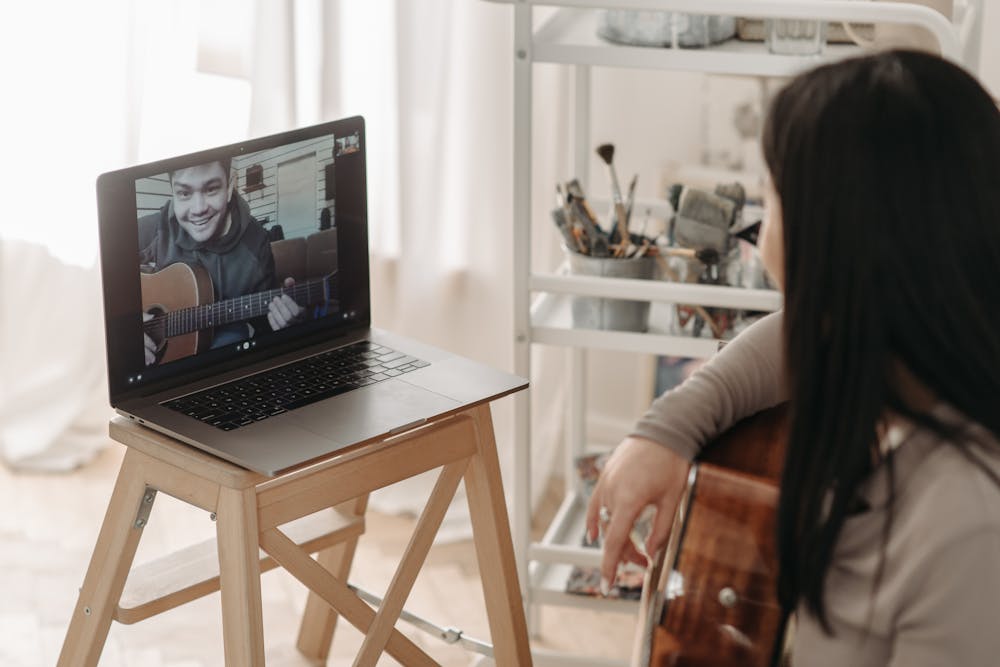 Photo by Pavel Danilyuk: https://www.pexels.com/photo/a-woman-in-brown-long-sleeves-playing-acoustic-guitar-7120397/