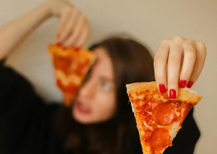 Photo by Maksim Goncharenok: https://www.pexels.com/photo/woman-in-black-long-sleeve-shirt-holding-sliced-pizza-4773768/